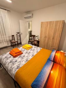 a bedroom with a large bed with colorful sheets at Casa Kokoro in Staranzano