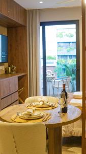 a table with plates and a bottle of wine on it at Luxury Studio in the heart of Playa del Carmen in Playa del Carmen