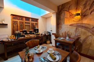 a restaurant with a table and chairs and a counter at Villa Kerasy Hotel Spa in Vannes