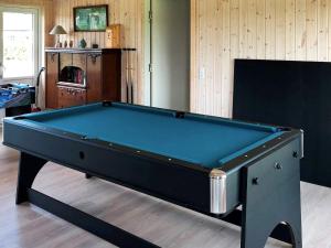 a pool table in a living room with at Scandinavian Lakeside Retreat-By Traum in Ansager