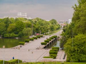 a street in a park next to a river at Parlament Residence in Bucharest