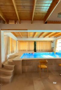 a large pool in a room with a table and chairs at Sarl piscine chaufente familial in Alger