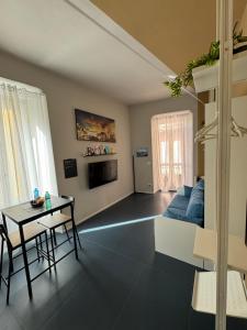 a living room with a blue couch and a table at Vicolo Muratori 1 in Moncalieri