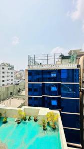 a swimming pool on the roof of a building at Hotel The Grand Hyatt Dhaka in Dhaka