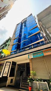 a large blue building with stairs in front of it at Hotel The Grand Hyatt Dhaka in Dhaka