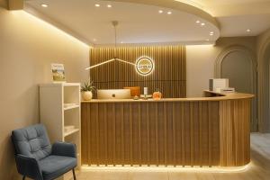 a waiting room with a chair and a counter at Hotel Paffhausen in Wirges