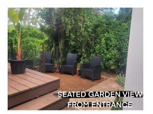 a group of chairs sitting on a patio at The Olive Room on Gallery Walk in Mount Tamborine +4 photos