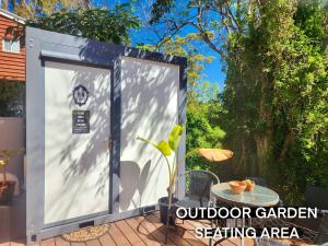 a out door garden setting area with a plant at The Olive Room on Gallery Walk in Mount Tamborine