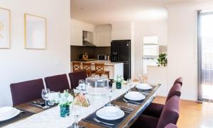 a dining room with a table and chairs at Bright, comfortable family home in leafy Forest Hill in Forest Hill