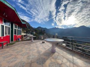 a patio with a table and a view of the mountains at hotel first view in Chopta