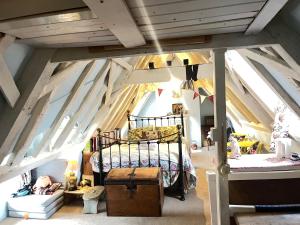 a bedroom with a bed in a attic at Walsingham Bakehouse in Little Walsingham