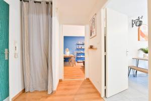 a hallway with a door leading into a living room at Candella in Strasbourg