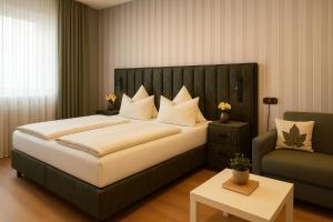 a bedroom with a large bed and a couch at Hotel Paffhausen in Wirges +21 photos