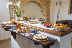 a buffet with many different types of bread and fruit at B&B Casa Cavour in San Benedetto del Tronto