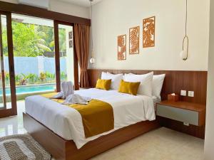 a bedroom with a large bed and a large window at ASAnA Guesthouse in Ubud +72 photos