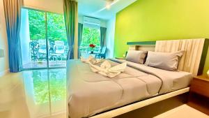 a bedroom with a bed with a flower on it at Abdullah Residence in Patong Beach