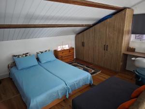 a bedroom with two beds and a cabinet at Kreolia Blue in Trou dʼ Eau Douce