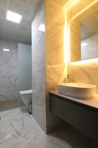 a bathroom with a sink and a toilet at Grand Zara Hotel in Kayseri