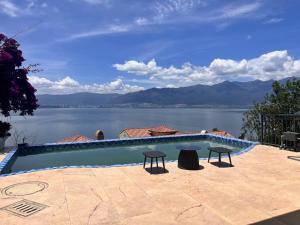 a swimming pool with a view of a body of water at Dali Tanuki Fantasy Seaview Villa in Dali
