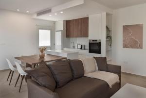 a living room and kitchen with a couch and a table at Avyra Residences Chrysakama Sea View in Polis Chrysochous