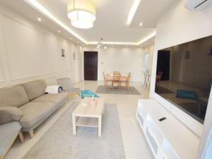 a living room with a couch and a table at white Bear in Madinaty