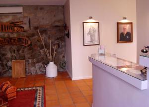 a room with a counter and a stone wall at Casa de Campo Patio do Avô - Varanda do Pátio in Routar
