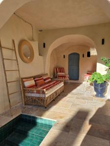 a living room with a couch and a pool at Charming village house 10 min from Uzès in Saint-Victor-des-Oules