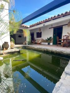 a house with a pond in the yard at Casa Cristal Habitación Andromeda in Chiapa de Corzo
