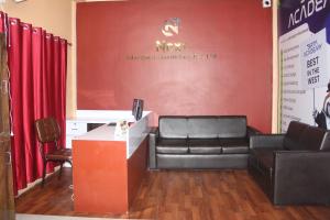 a waiting room with a leather couch and a table at next open Hostel in Pokhara