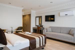 a hotel room with a bed and a couch at Blue Istanbul Hotel Taksim in Istanbul