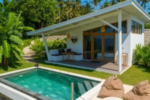 a villa with a swimming pool in front of a house at EDEN Private Pool Suites and Panoramic Agung View - ADULT ONLY in Nusa Penida
