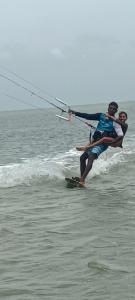 two people are on the water in the ocean at Kitelife Resort in Kalpitiya +43 photos
