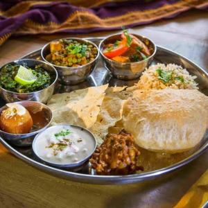 a tray of food with different types of food on it at Samaira home stay in Bīr