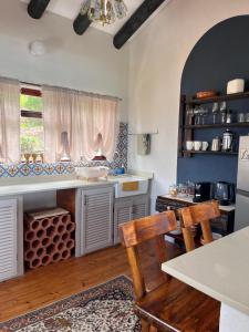 a kitchen with a table and a chair in a room at Vistas al Mar in Groot Brak Rivier +15 photos