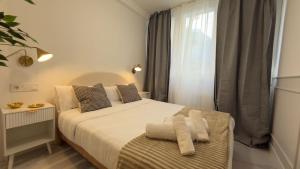 a bedroom with a bed with towels on it at Viana apartaments in Bilbao