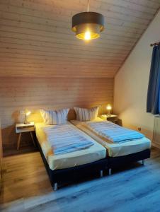 a bedroom with two beds in a room at Pension Schneider, Bad Gögging in Neustadt an der Donau