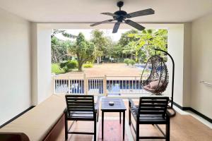 a dining room with a table and chairs and a swing at Ramada by Wyndham Aonang Krabi in Ao Nang Beach