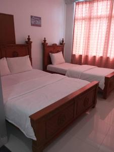 Ένα ή περισσότερα κρεβάτια σε δωμάτιο στο Hotel Nusantara