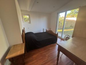 a bedroom with a bed and a large window at Villa Amistad in Mont-de-Marsan