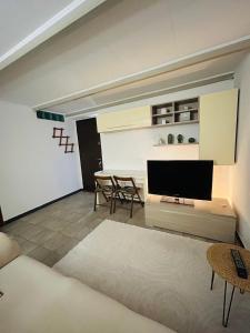 a living room with a television and a table at BnB Sabrina Home Milano in Cornaredo