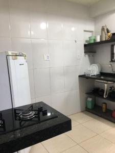 a kitchen with a stove and a counter top at Pousada Recanto do Hibisco in Prado