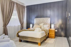 a bedroom with a large bed and a window at Spacious Valkyrie One-bedroom in Centurion