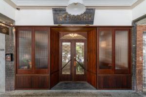 a wooden door in a building with a sign above it at 安樓文旅 Enzo House in Keelung +173 photos