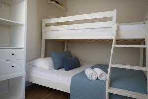 a small bedroom with a bunk bed and a ladder at Appartement cœur de ville avec balcon - 3 personnes in Les Sables-dʼOlonne