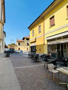 a street with tables and chairs and a building at BnB Sabrina Home Milano in Cornaredo +39 photos