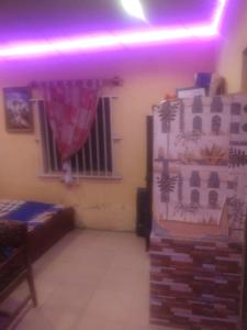 a room with a bed and a window at Ensuite in Ejigbo