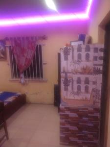 a living room with a purple light on the ceiling at Ensuite in Ejigbo +2 photos