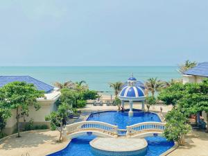 an aerial view of a resort with a bridge and the ocean at Lan Rung Beach Resort in Long Hai