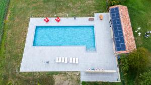 an overhead view of a swimming pool with solar panels at Casalino di Sopra in Tredozio