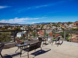 a patio with a table and chairs on a balcony at Hotel Marioni in Tbilisi City